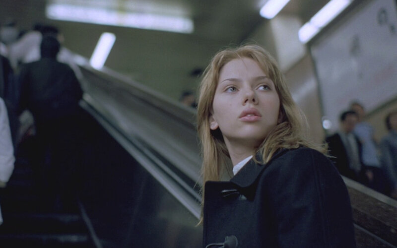 woman on escalator looking up