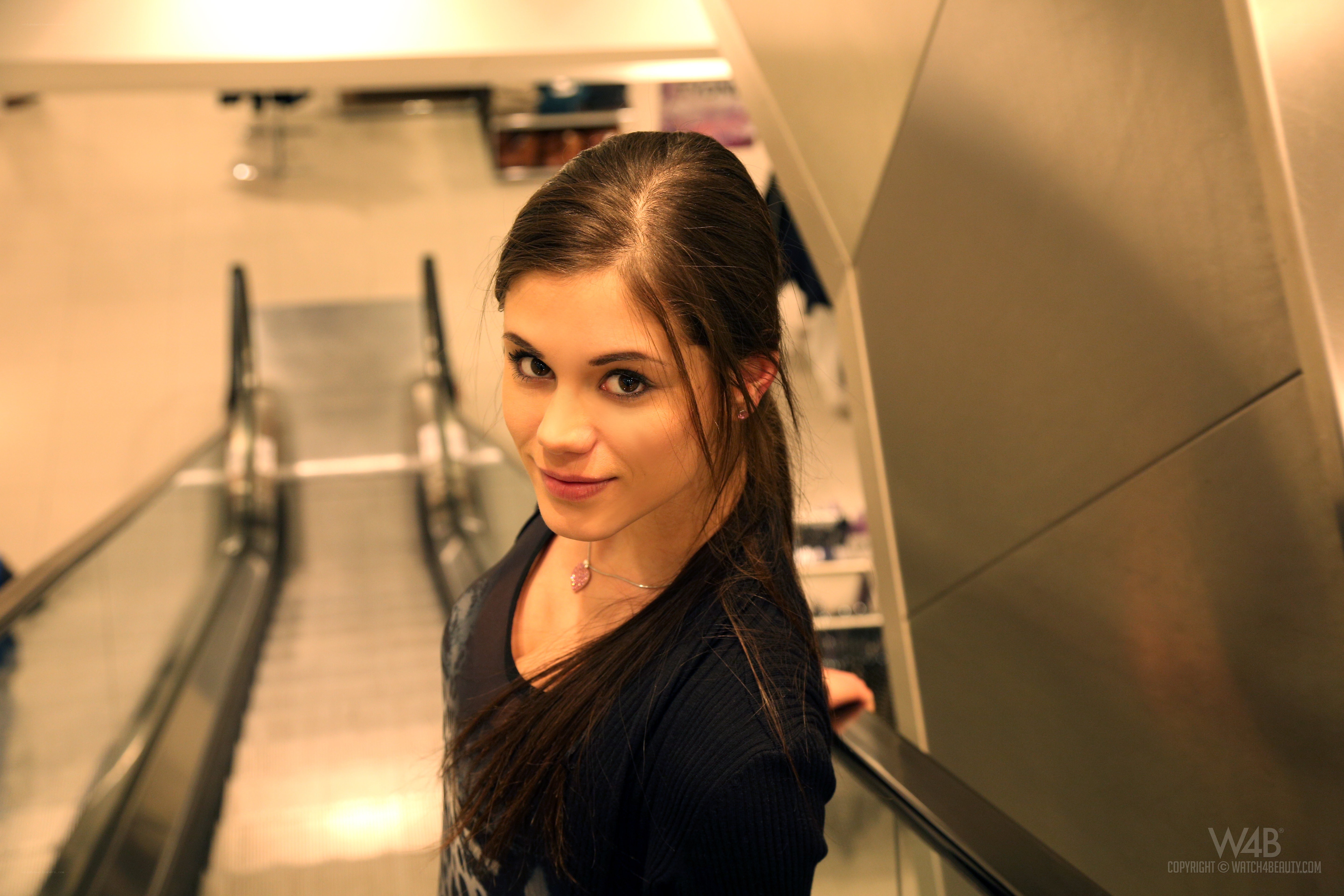 Woman on escalator smiling