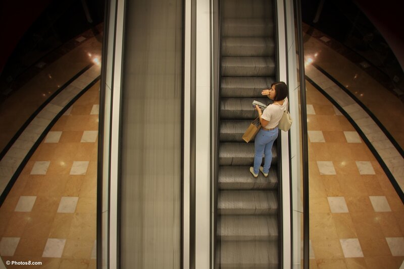 Woman on Escalator