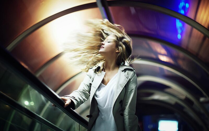 woman on escalator with hair blowing