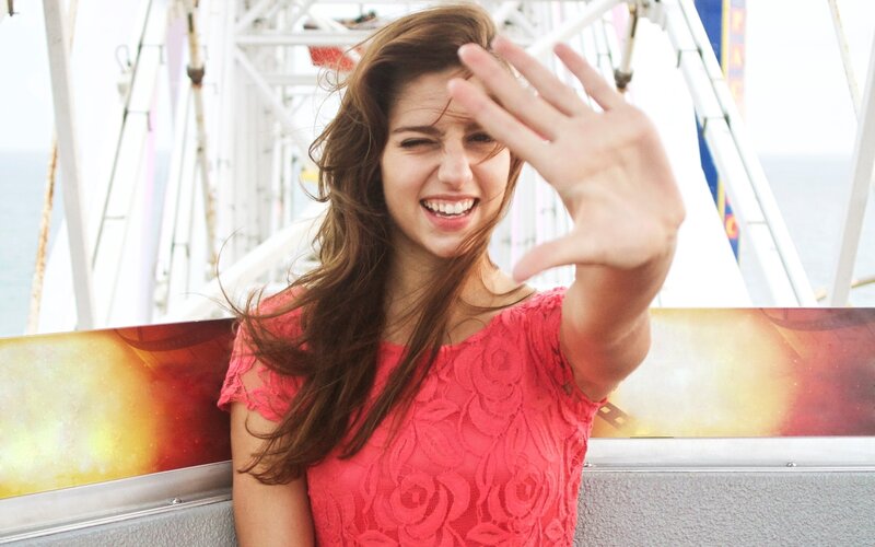 woman on ferris wheel waving