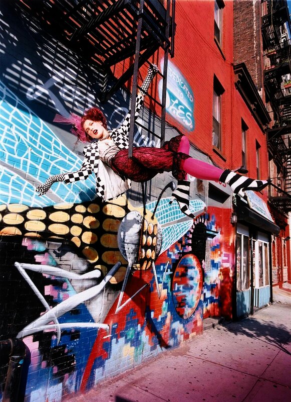 woman on fire escape with graffiti