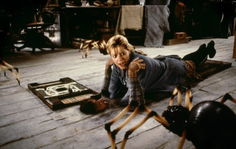 Woman on floor with giant spiders