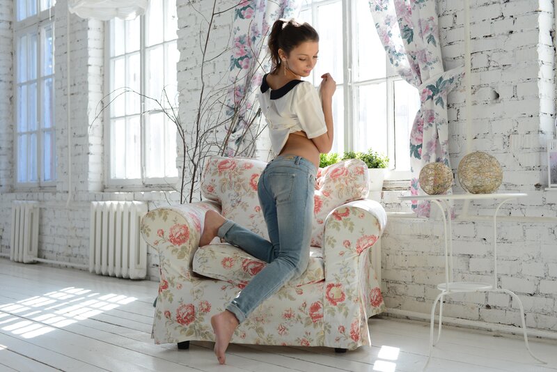 Woman on floral armchair