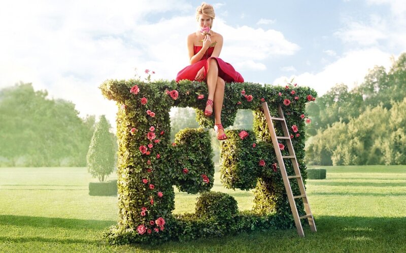 Woman on floral letter E