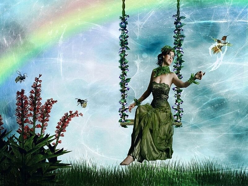 woman on floral swing in fantasy garden