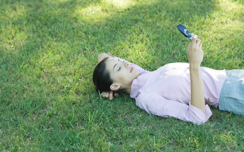 Woman on grass with phone