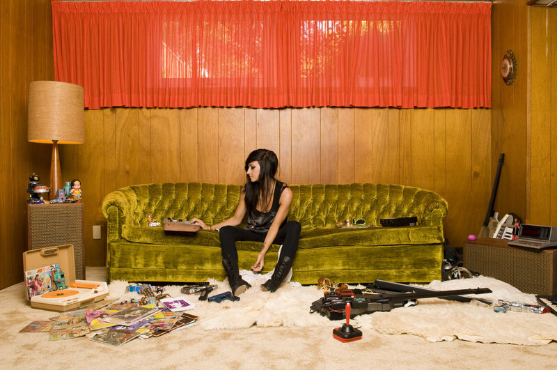 woman on green couch with toys