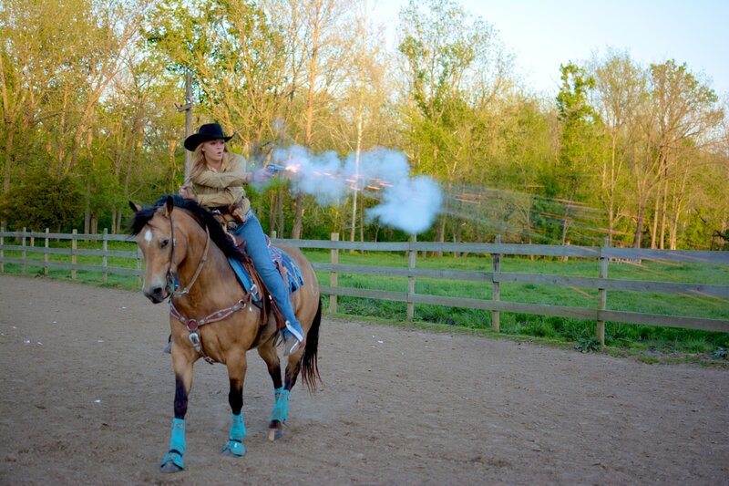 Woman on Horse Shooting Gun