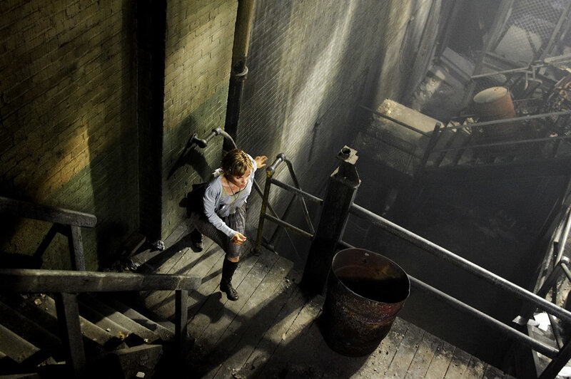 Woman on industrial staircase