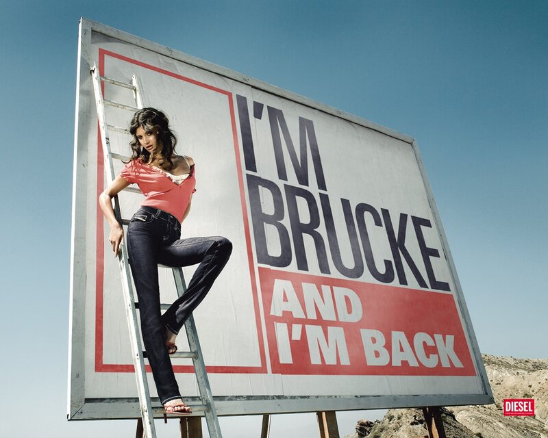 Woman on ladder by billboard