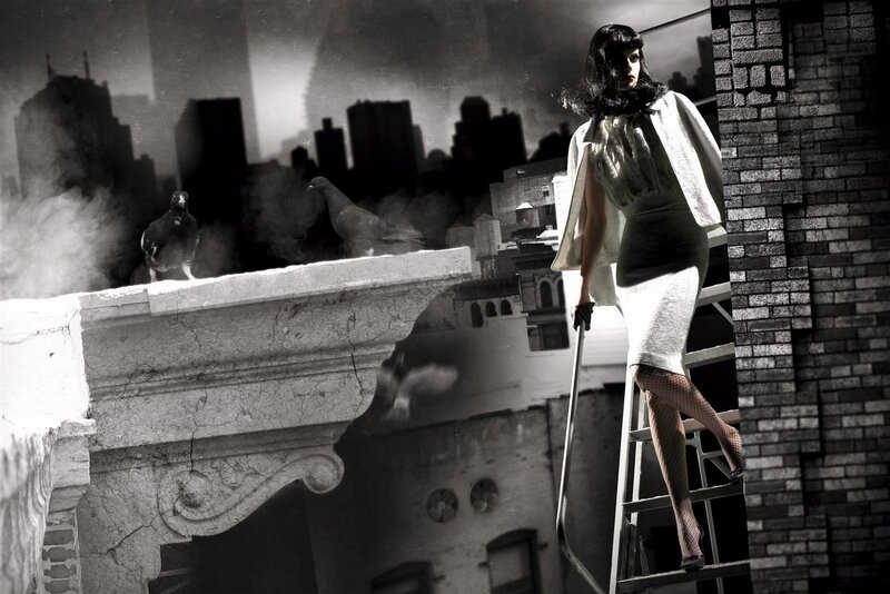 woman on ladder in cityscape
