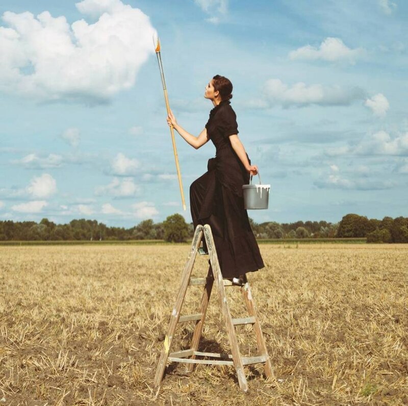 Woman on Ladder Painting — Brown
