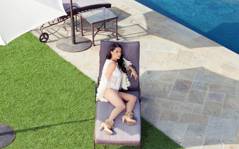 Woman on lounge chair by pool