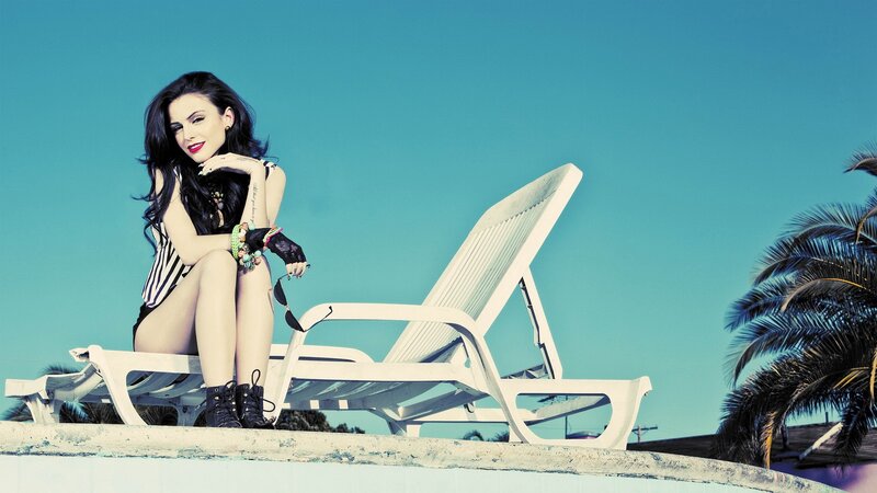 woman on lounge chair by pool