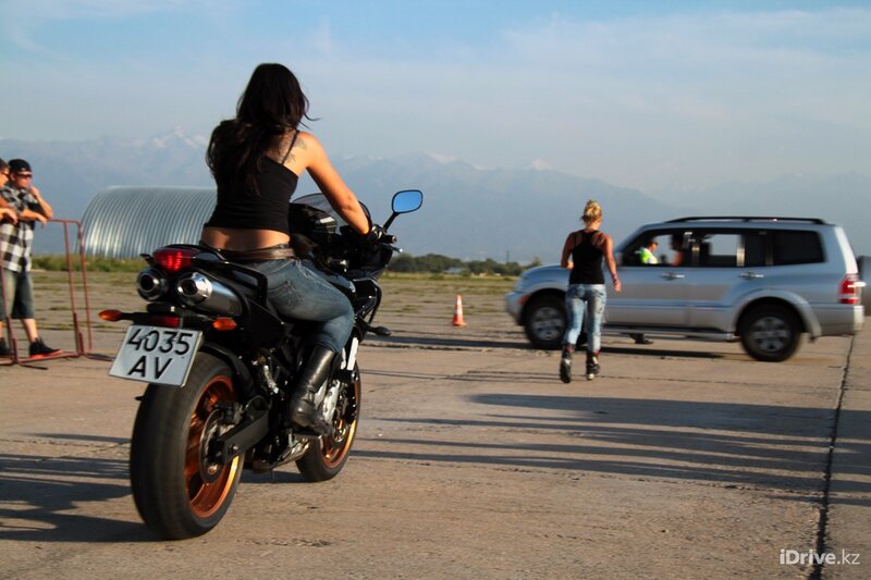 Woman on motorcycle at airfield