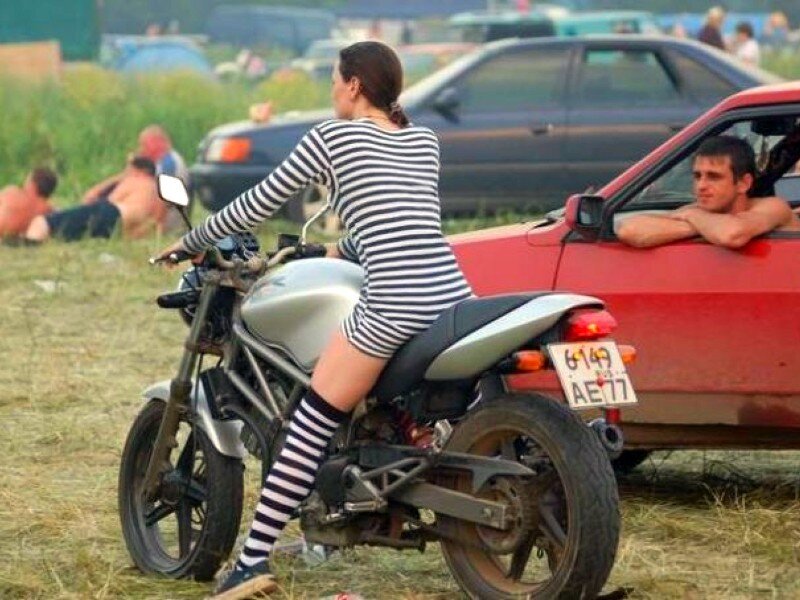 Woman on motorcycle at outdoor event
