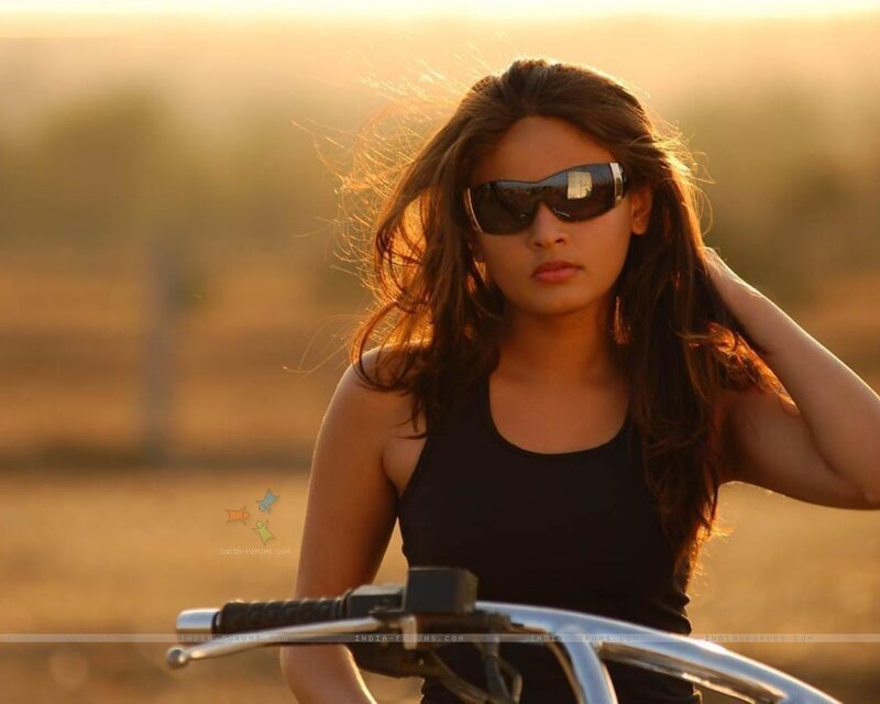 woman on motorcycle at sunset