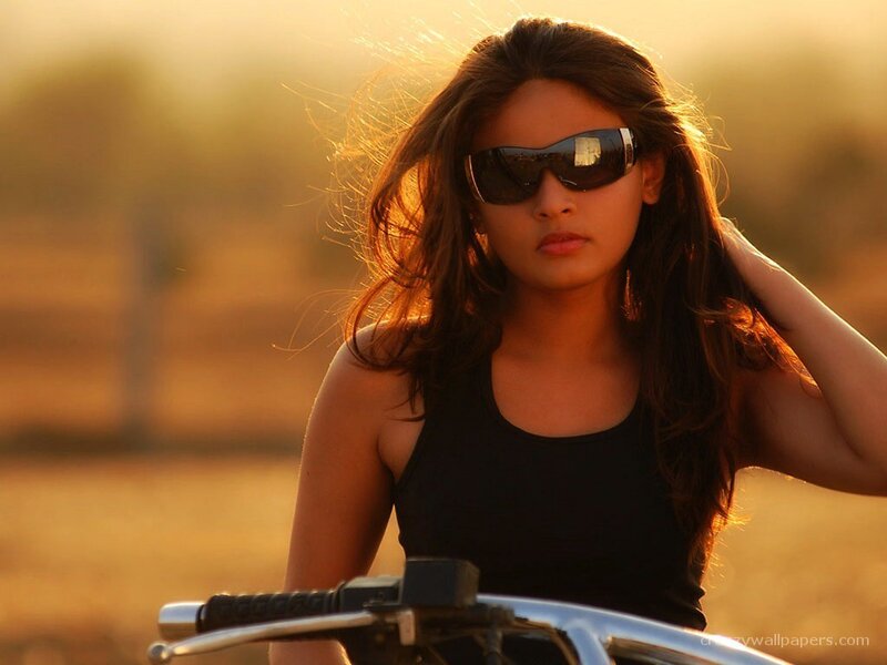 woman on motorcycle at sunset