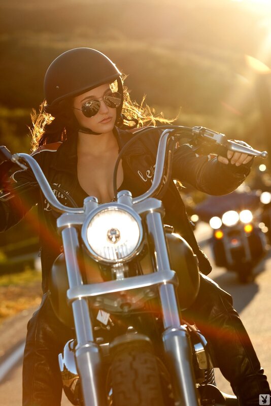 woman on motorcycle at sunset