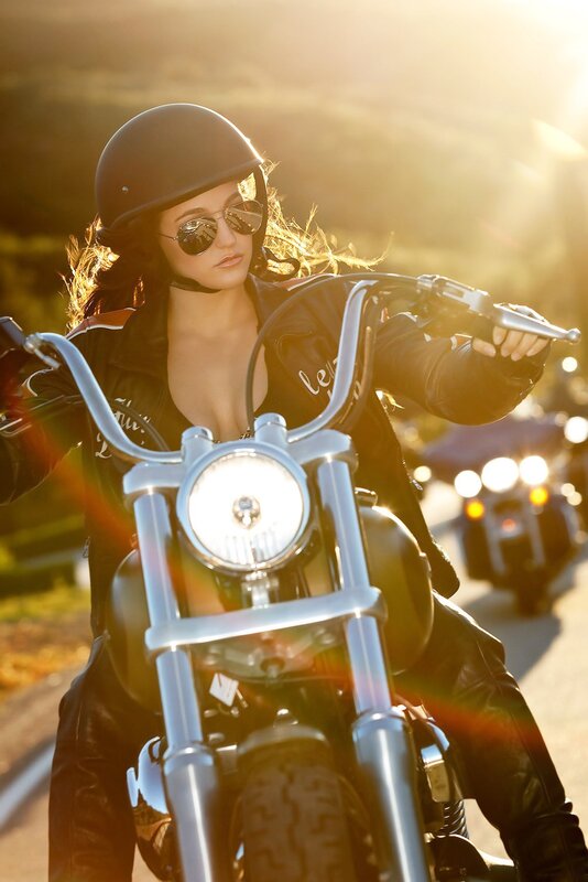 woman on motorcycle at sunset