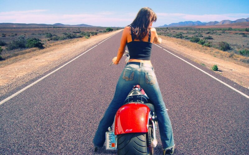 Woman on motorcycle in desert