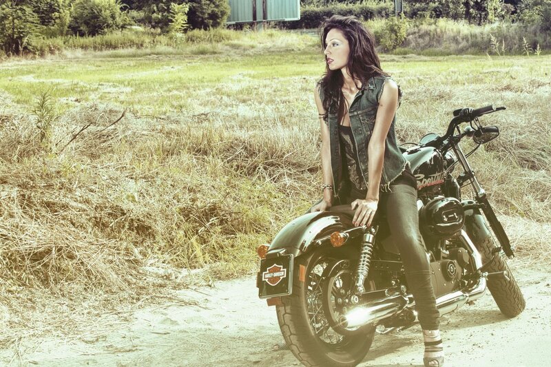 woman on motorcycle in field