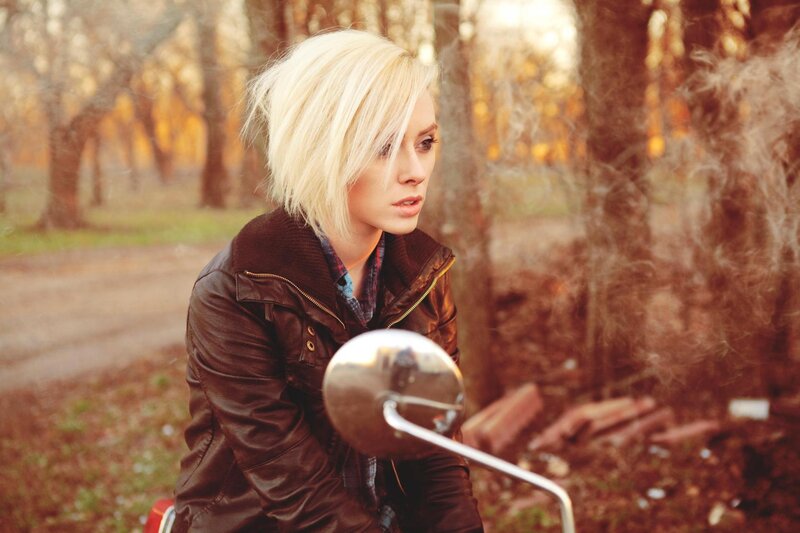 woman on motorcycle in forest