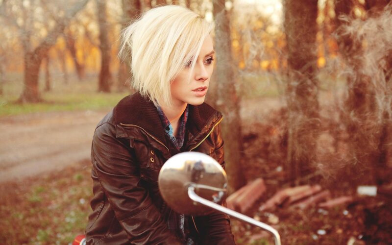 woman on motorcycle in forest