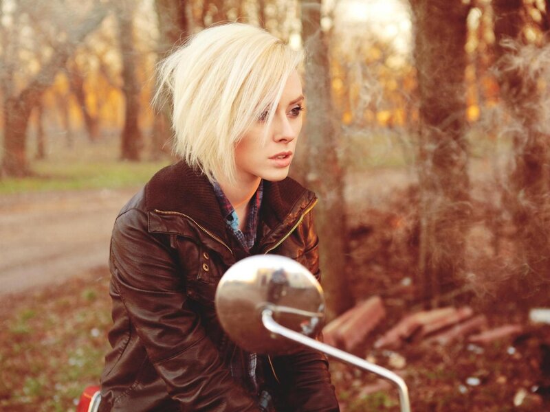 woman on motorcycle in forest