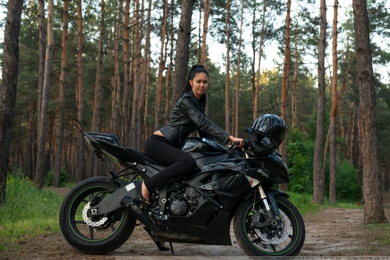 Woman on motorcycle in forest