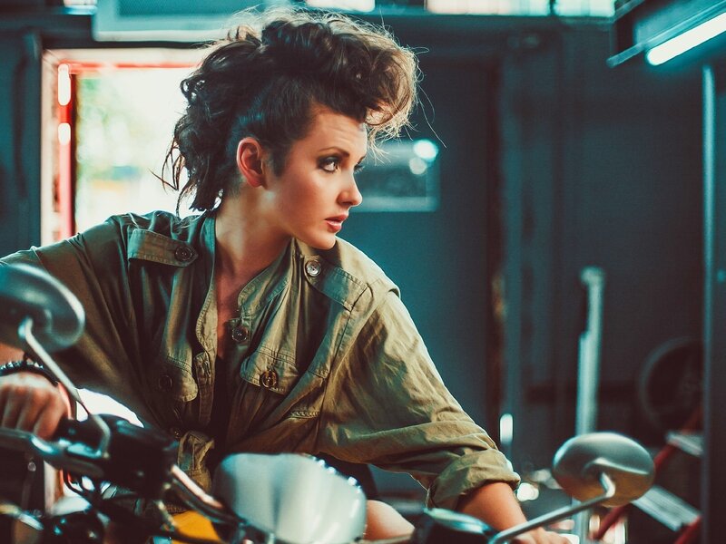 woman on motorcycle in garage