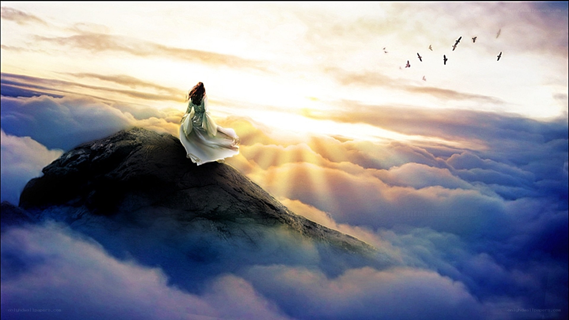 woman on mountain above clouds