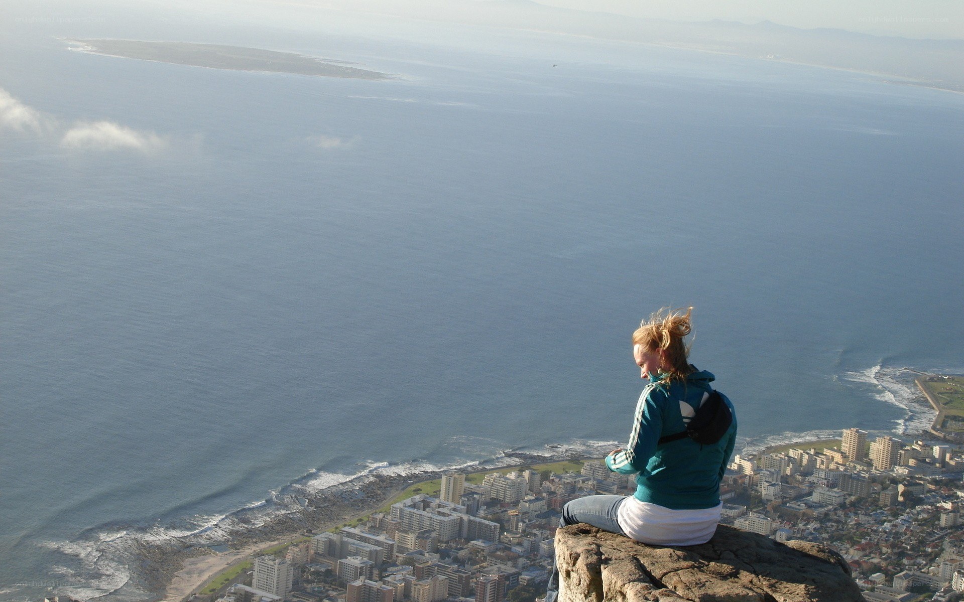 Woman on mountain overlooking city