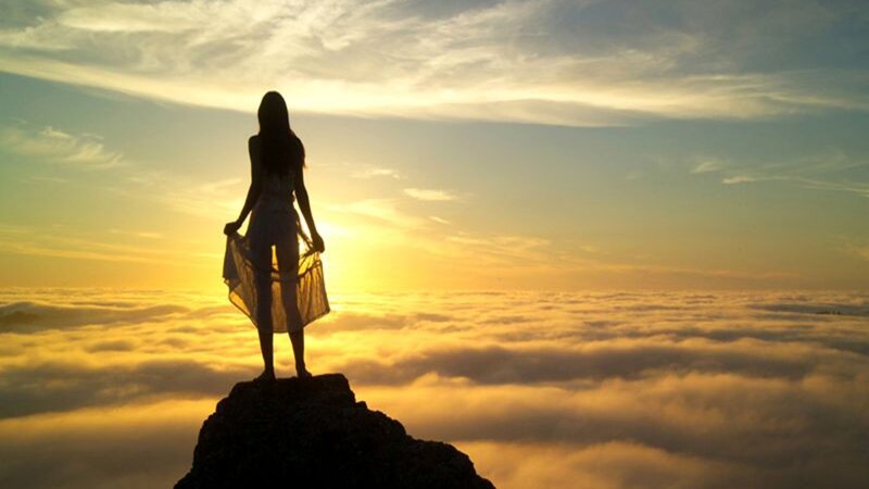 Woman on Mountain Peak — Yellow