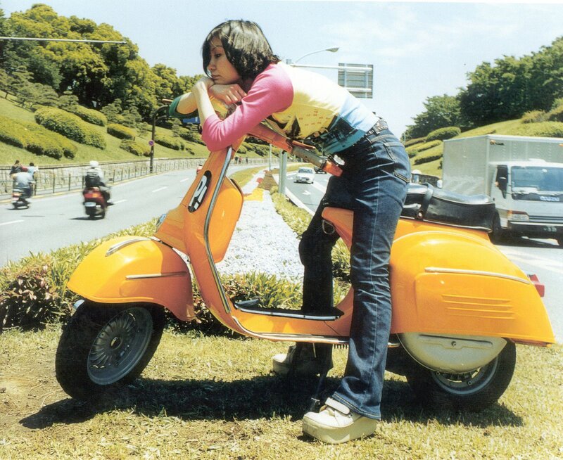 Woman on orange scooter