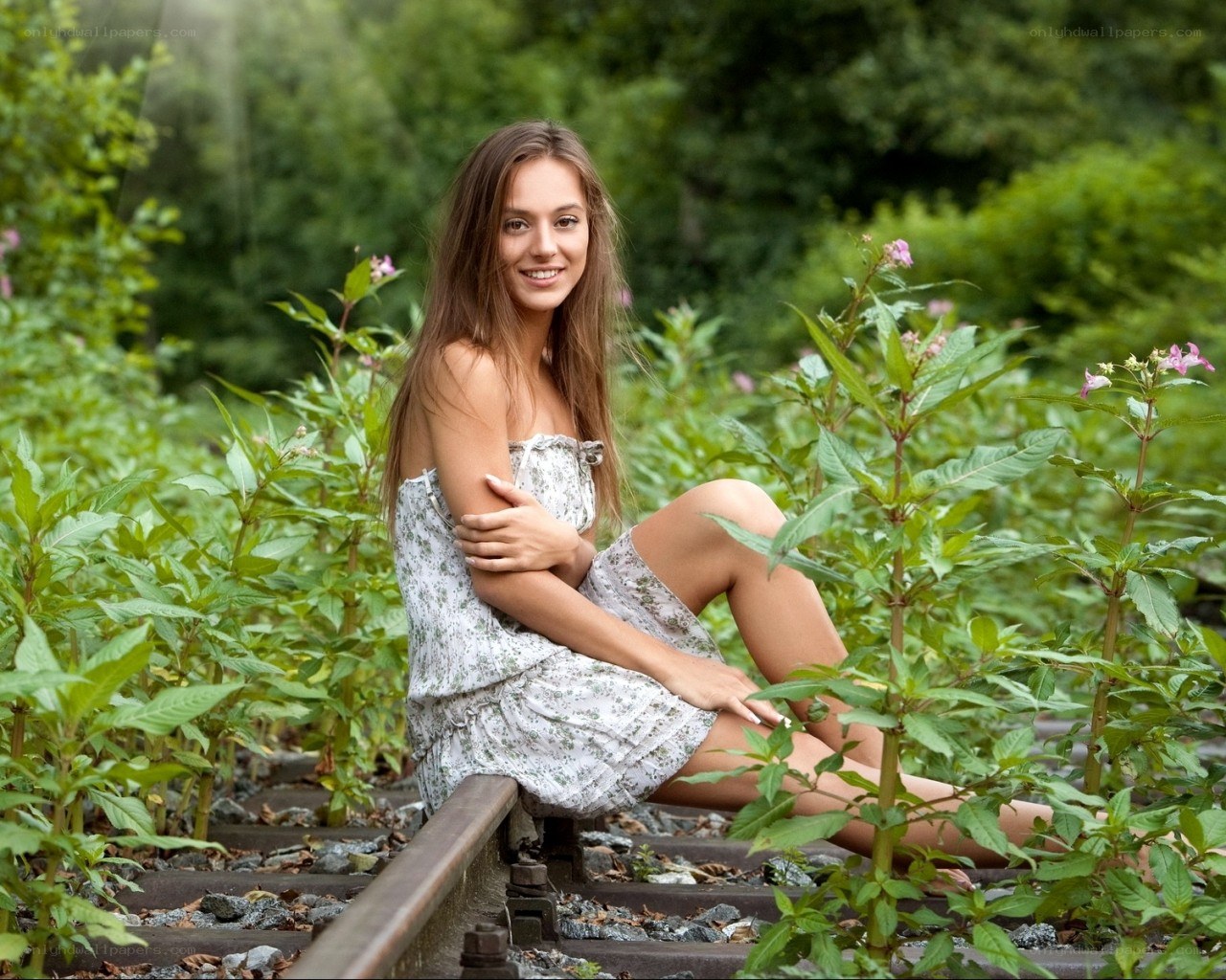 Woman on overgrown train tracks