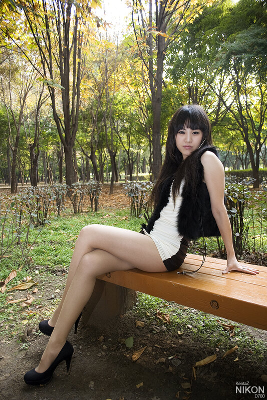 Woman on park bench in autumn