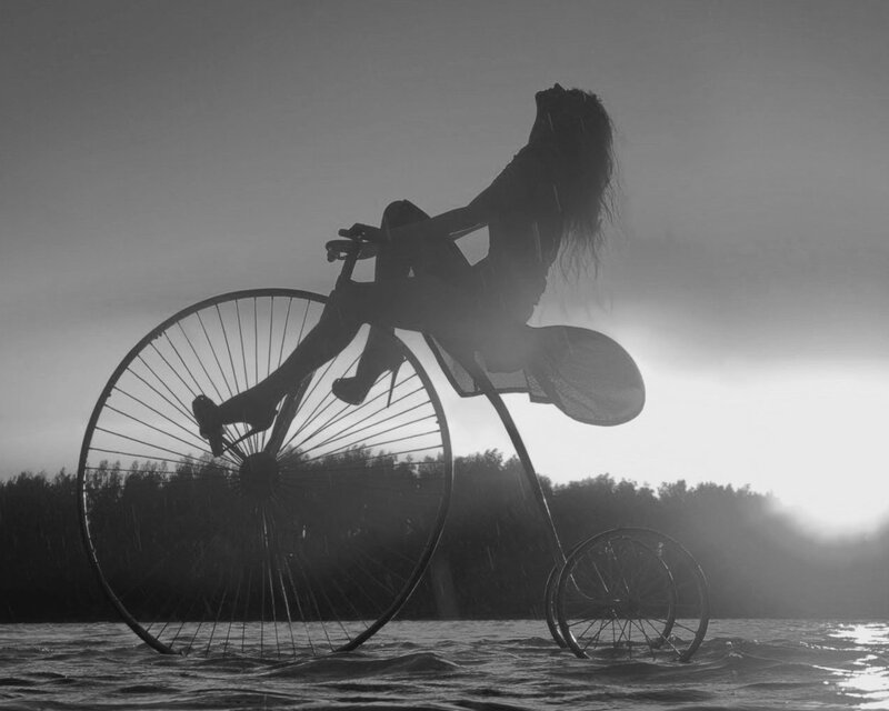 woman on penny-farthing bicycle
