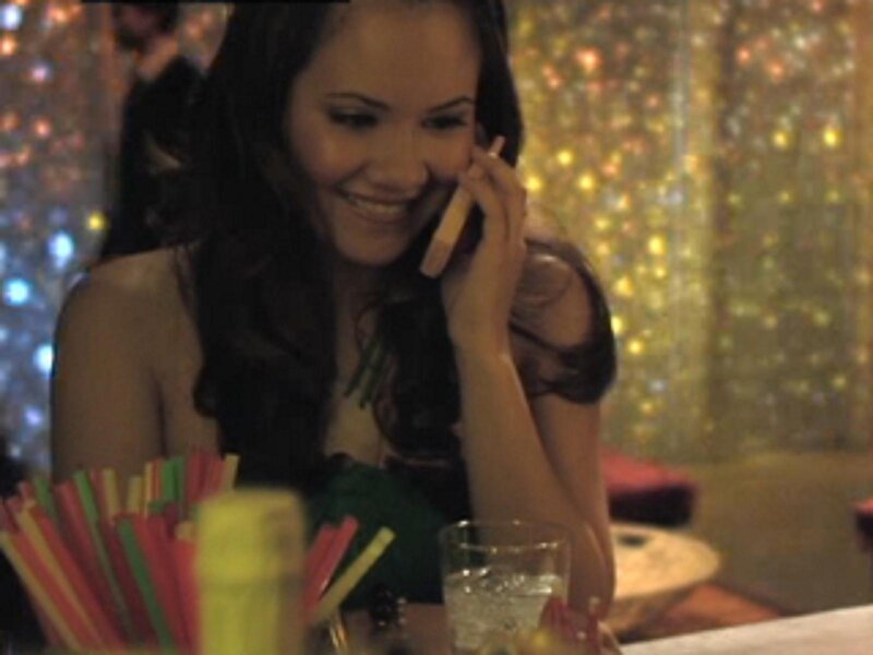 woman on phone at bar