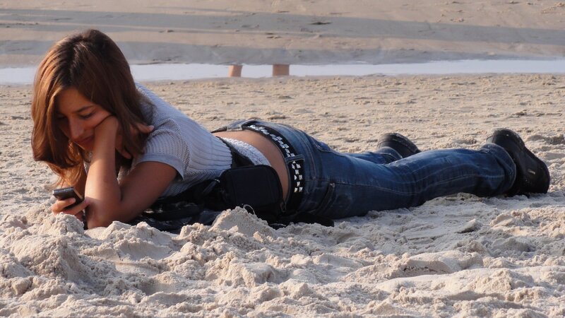 Woman on phone at the beach