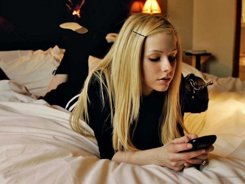 woman on phone in bed