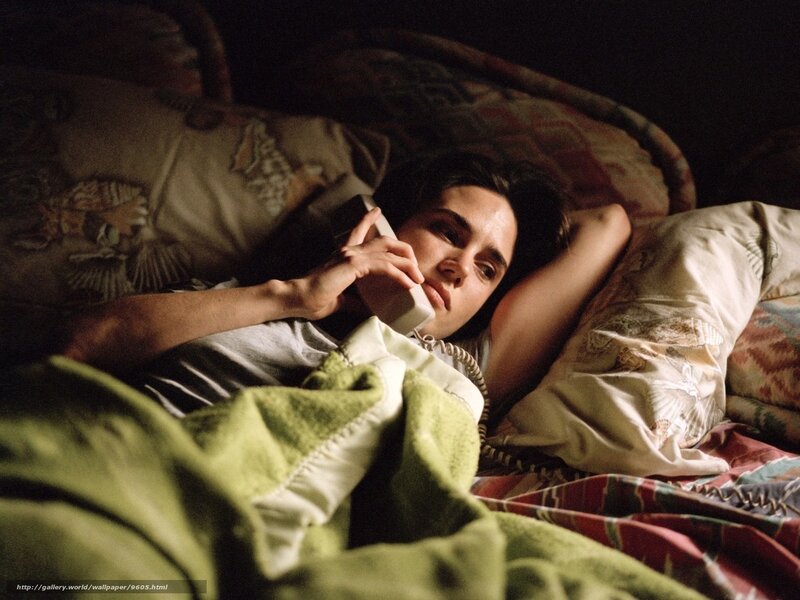 woman on phone in bed