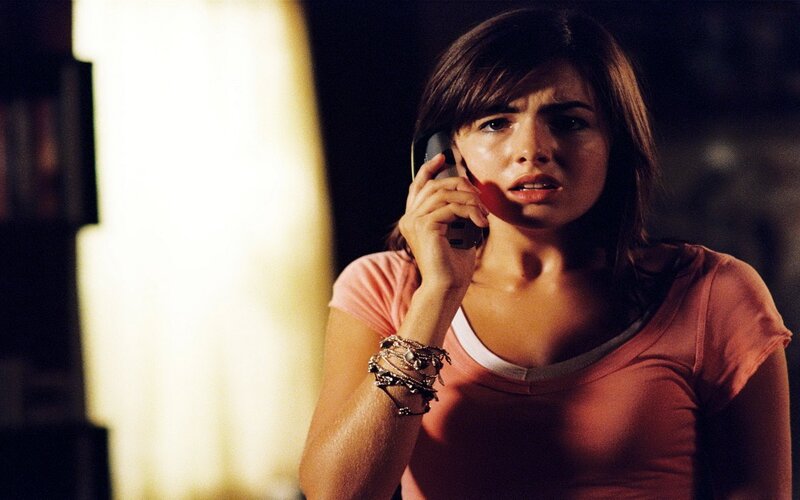 woman on phone in dark room