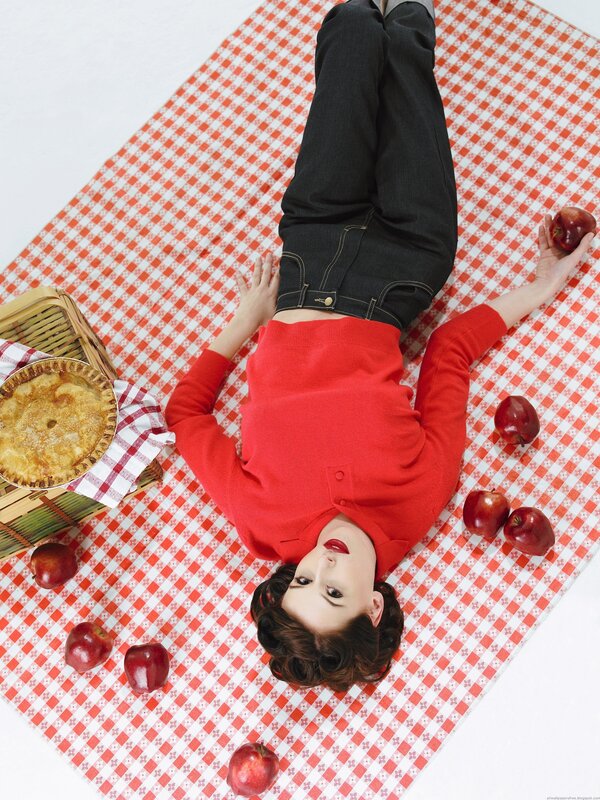 Woman on picnic blanket with pie