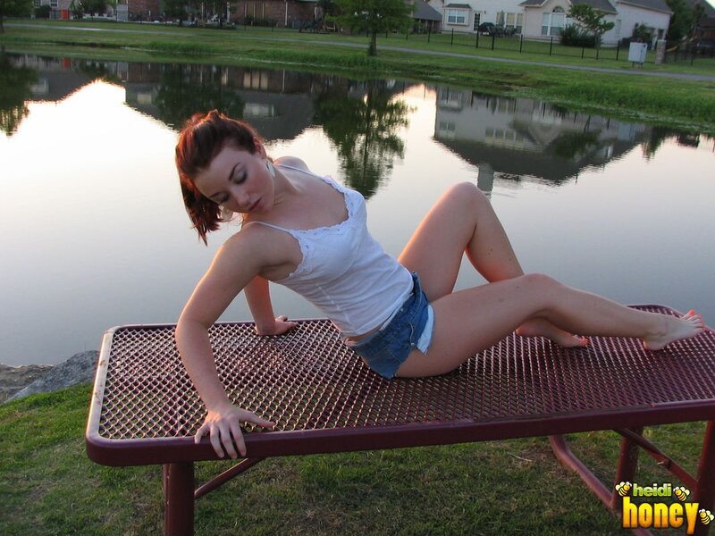 woman on picnic table by pond