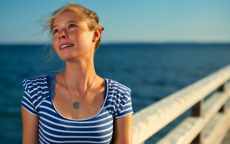woman on pier at sunset