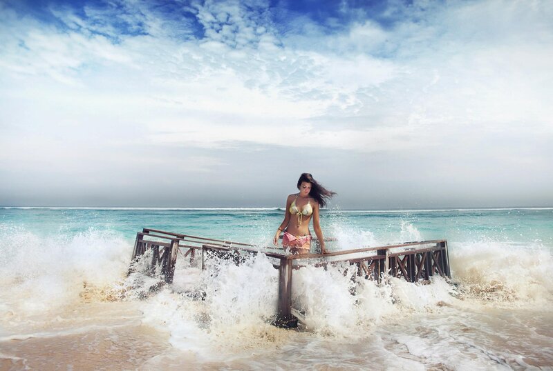 Woman on pier in ocean waves