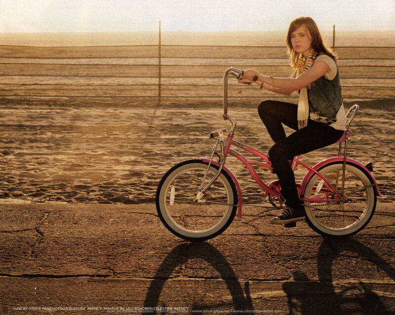 woman on pink bicycle at beach