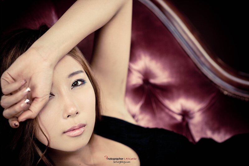 Woman on Purple Couch — Dramatic, Photograph